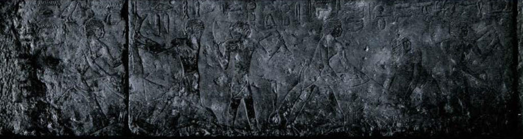 Low relief on a stone wall showing two butcher scenes