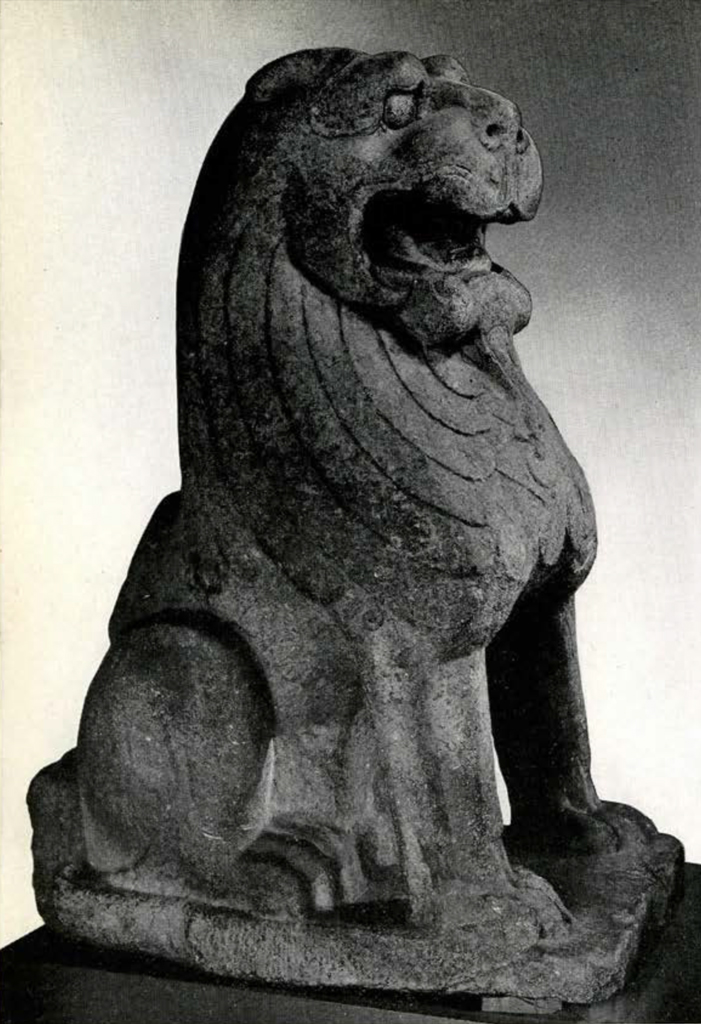 Massive carved stone seated lion with mouth open
