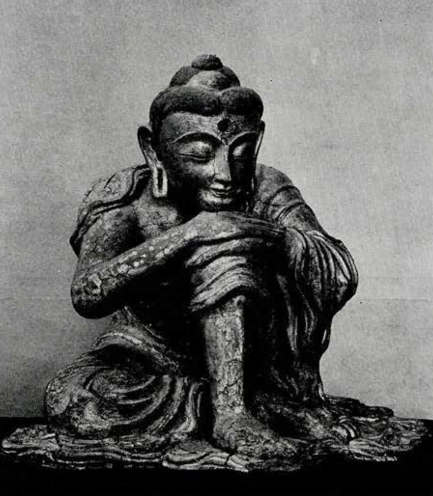 Seated figure of Sakyamuni Buddha in meditation with chin leaning on his hands which are joined over the raised left knee