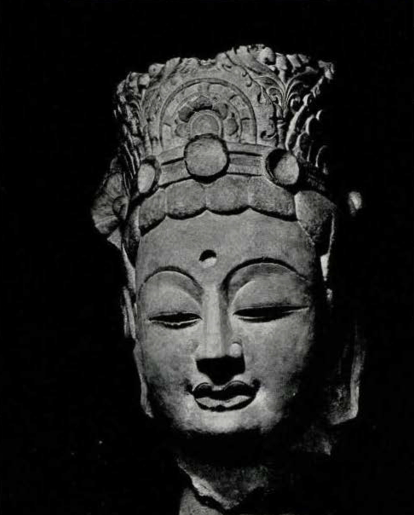Colossal head of a bodhisattva statue, plaited hair, crown, and empty urna