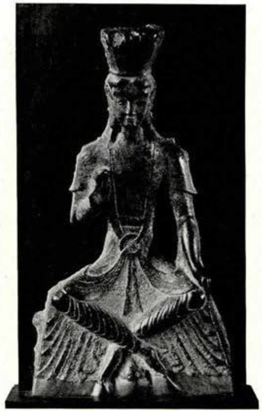 Carving of a seated Maitreya Buddha with hand in the abhaya mudra