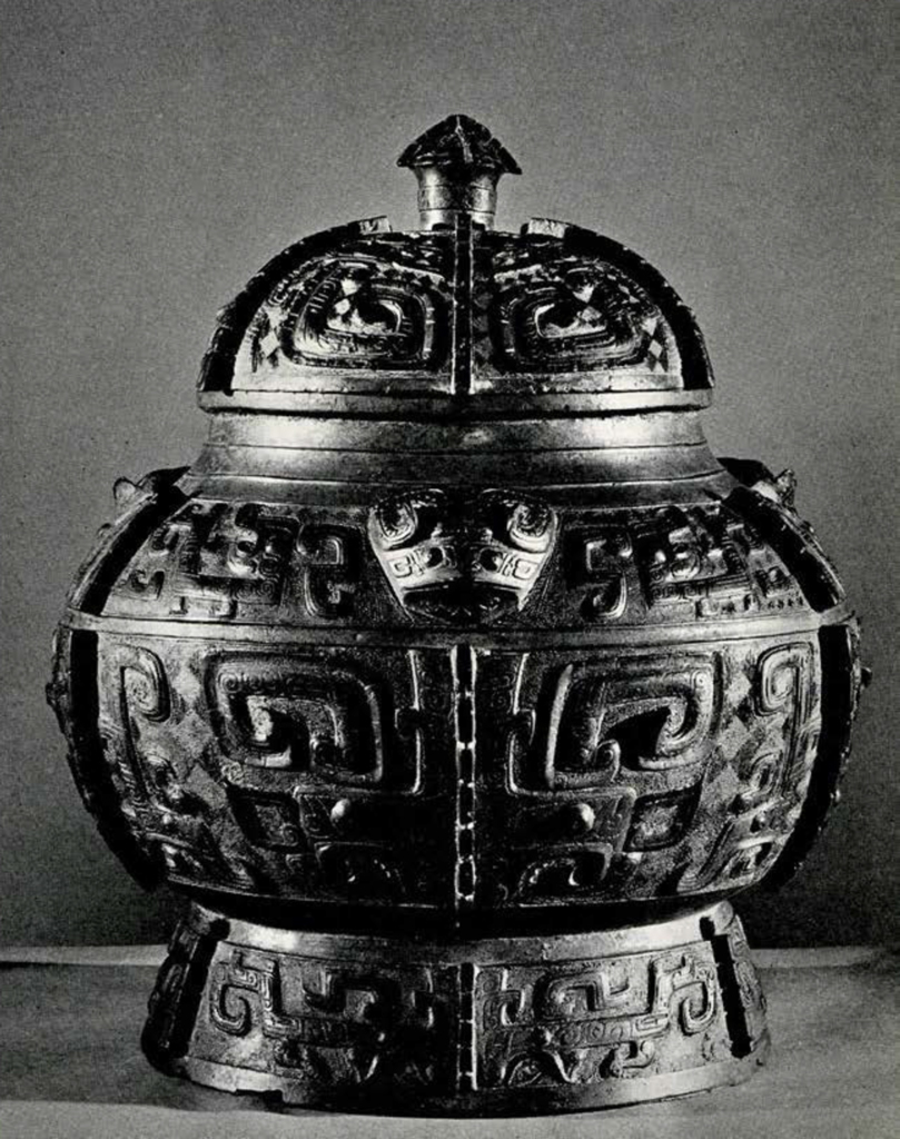 A bronze covered wine jar with bulbous middle and geometric decoration