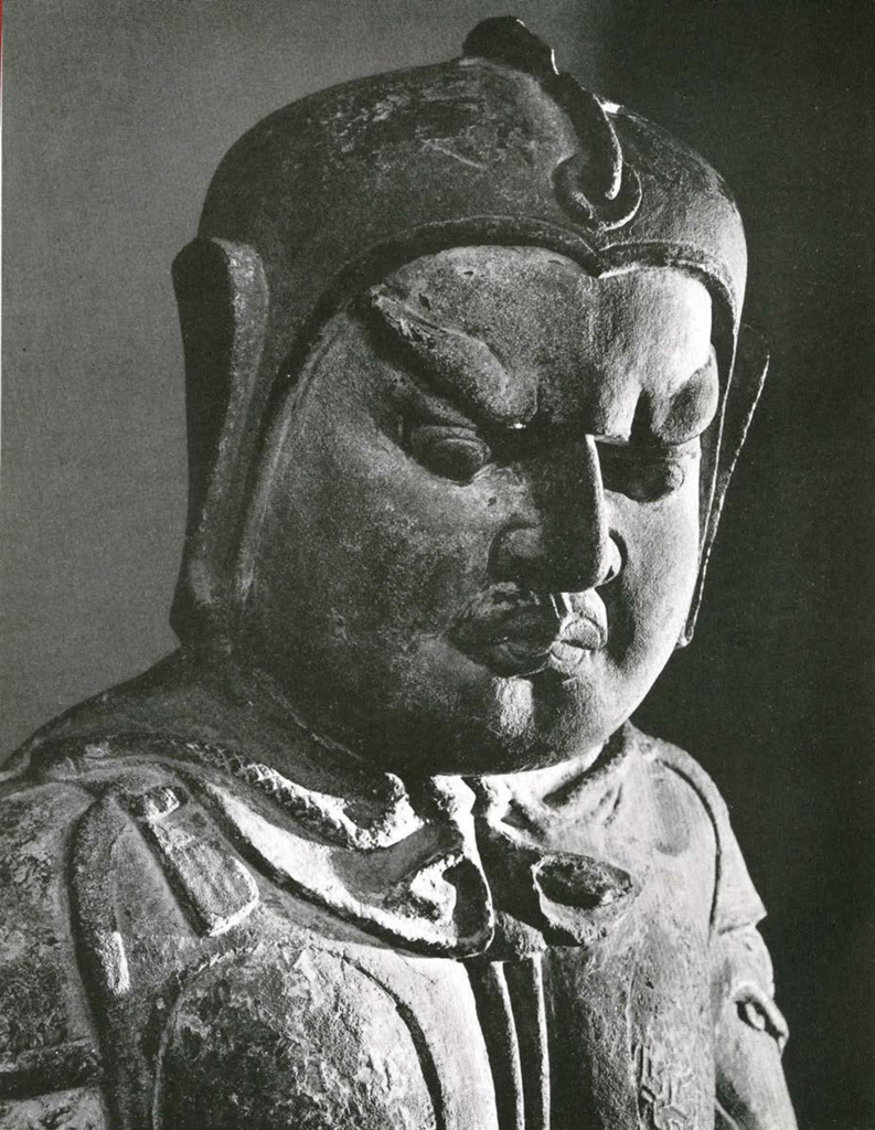Close up of lokapala face, man snarling with brow furrowed, wearing a helmet