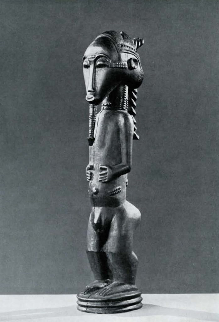 Wooden sculpture of a male figure with hands on belly and long wrapped beard