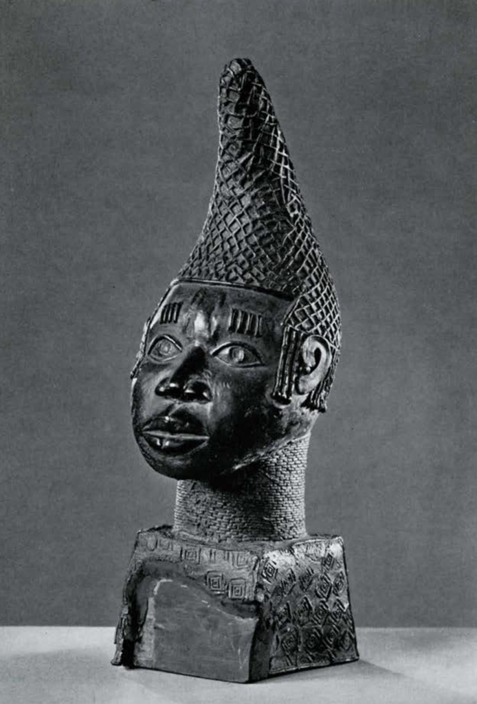 Bronze head and neck, wearing a conical hat