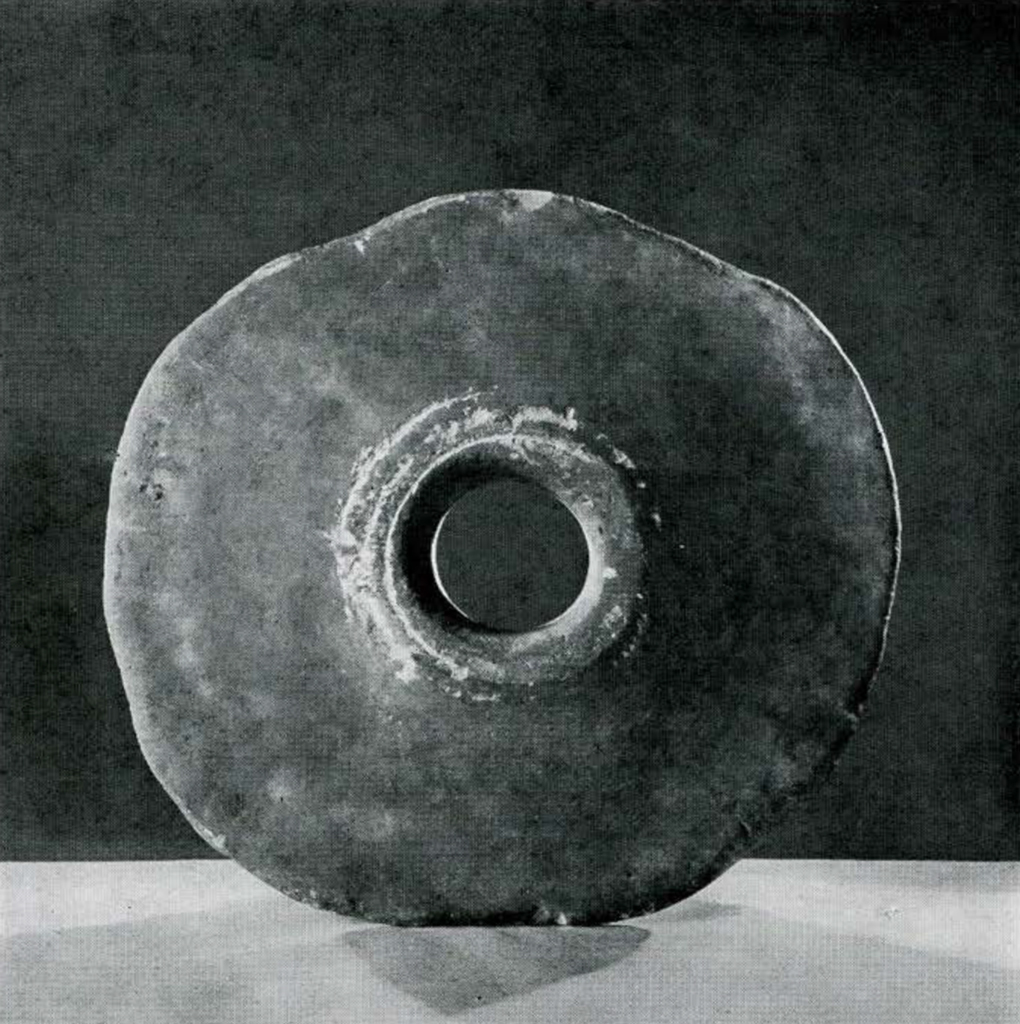 Flat stone disc with a hole in the middle