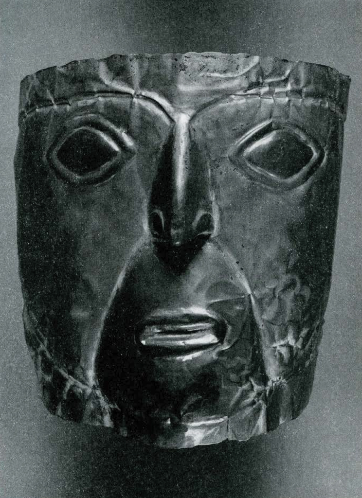 A gold repousse mask.