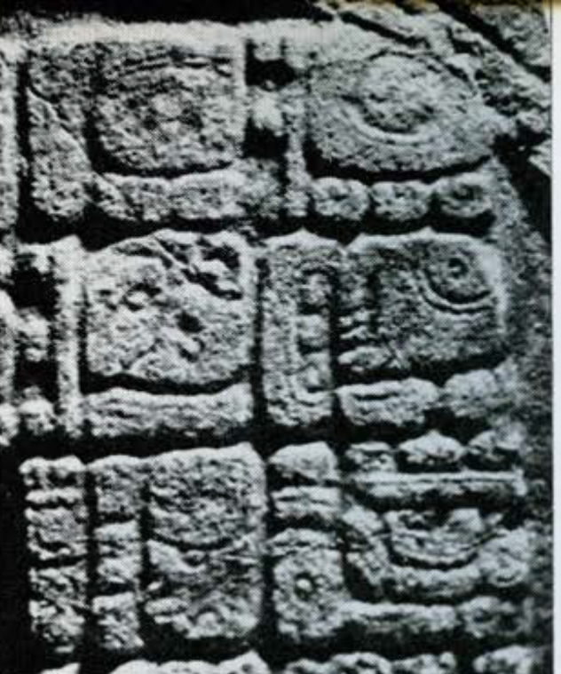 Close up of carved glyphs into a stone altar, Altar 12.