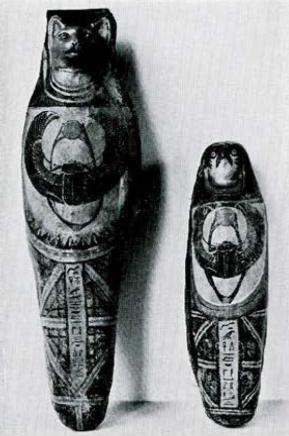 Cartonnage for a cat and a falcon, both with a scarab on the breast and holding red discs.