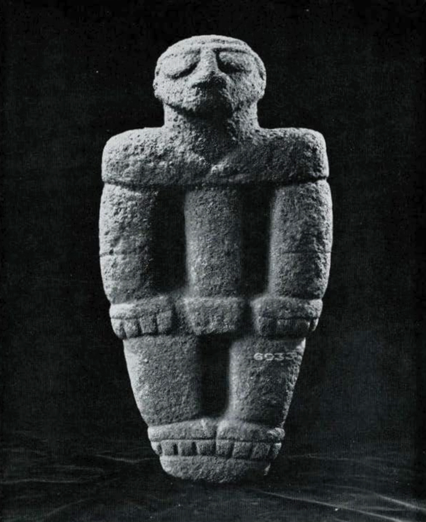 Small stone carving of a standing man.