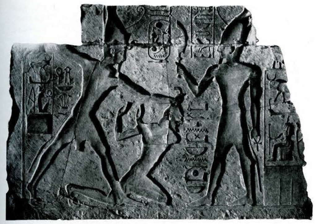 Temple facade wall fragment: Ramses II is depicted slaying an Asiatic enemy in this relief fragment, the god Atum offers the sword of victory to the king in exchange for the ritual sacrifice of the captive.