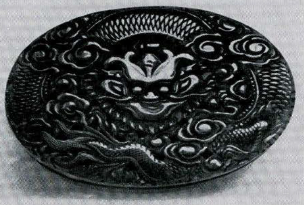 Ovular buckle with dragon carved into it.