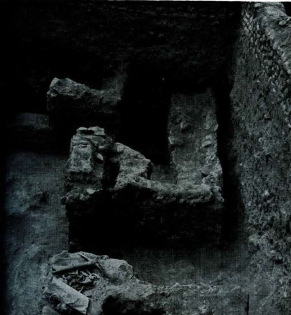 Partially excavated stone walls of a house.