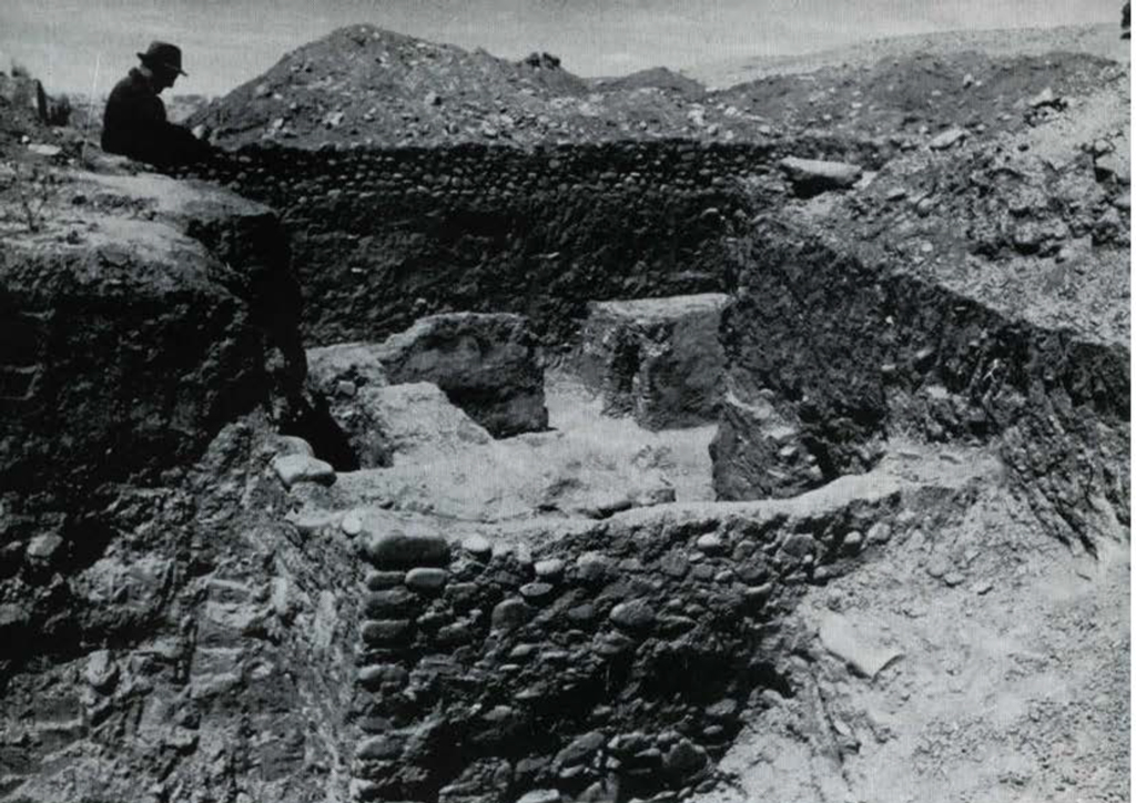 Partially excavated stone walls of a house.