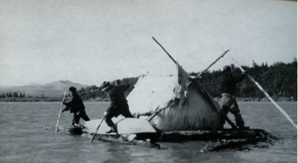 Three people paddiling a raft with a tent on it in a lake.