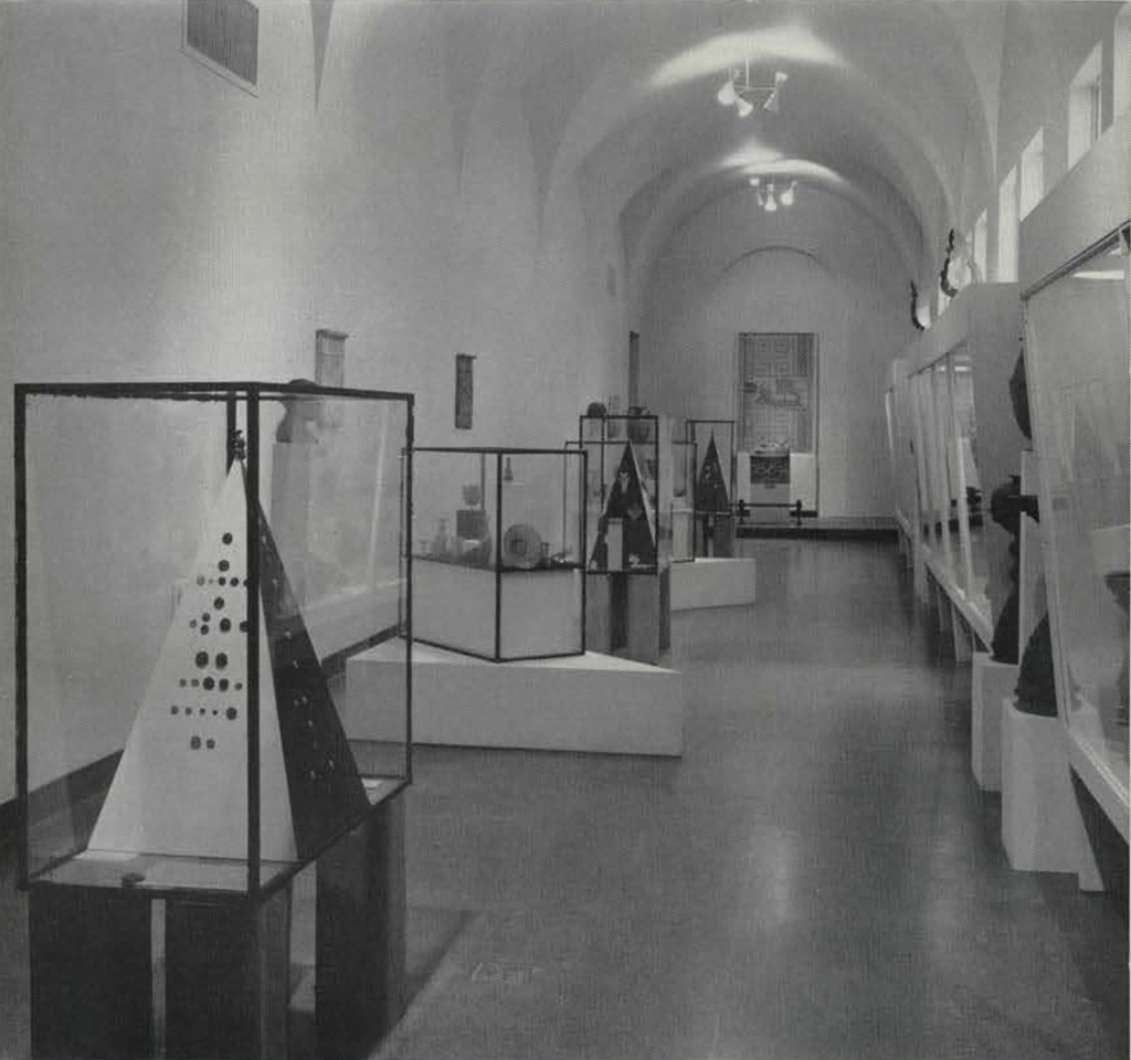 View of the Inner Gallery hshowing objects in glass cases lining a hall.