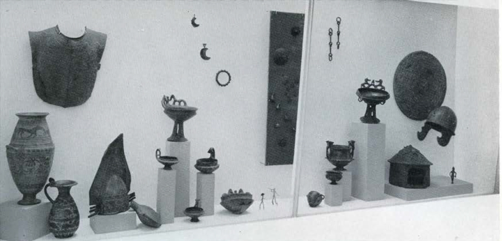 A variety of Italian objects in a glass case.
