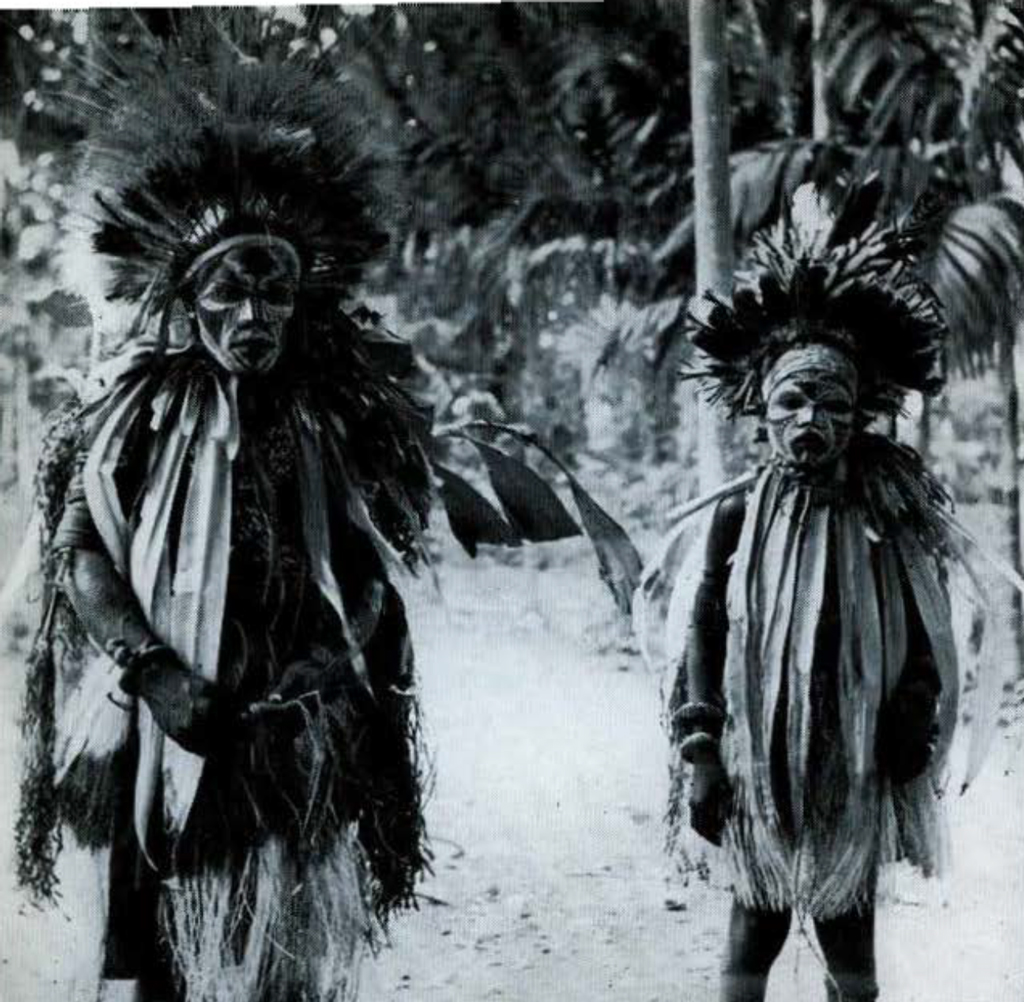 A man and a boy in ceremonial dress.