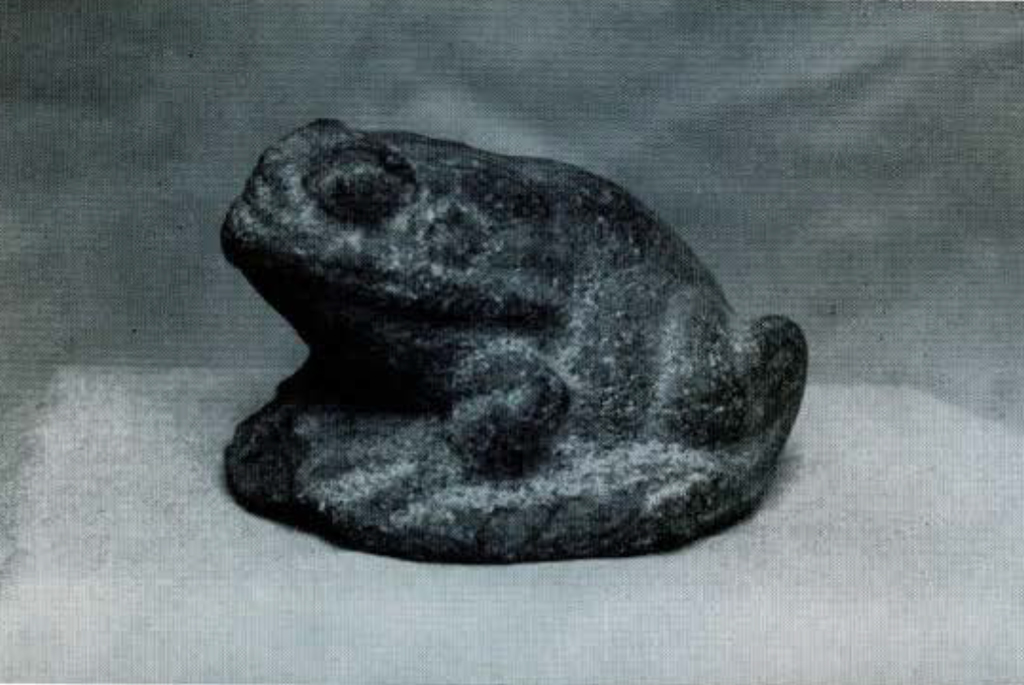 A small stone carving of a toad.