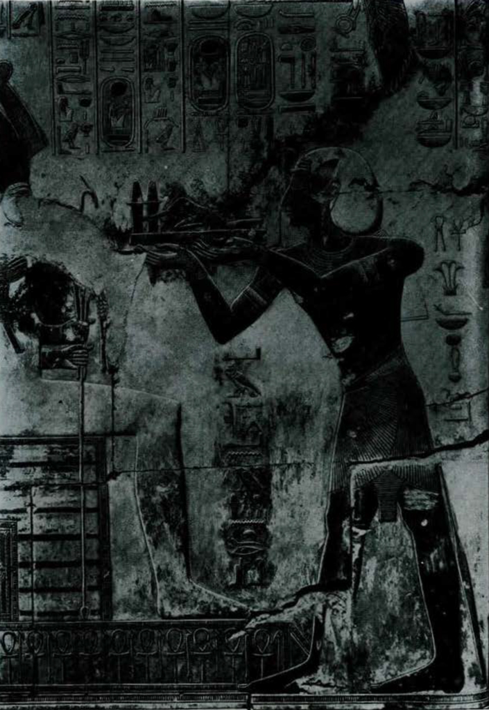 Depiction on a wall showing Seti I offering himself to a seated Osiris.