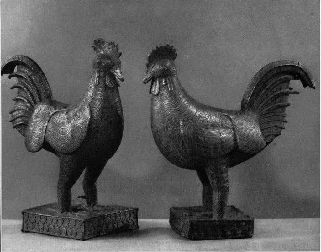 Two bronze roosters.