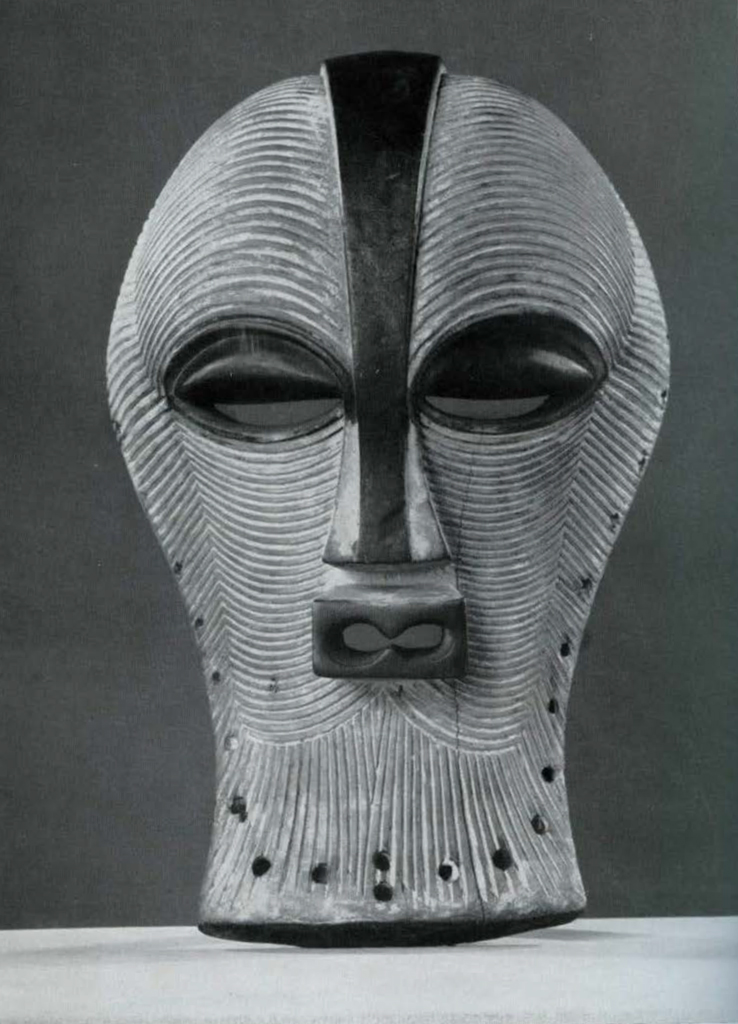 Wooden mask covered in striations.