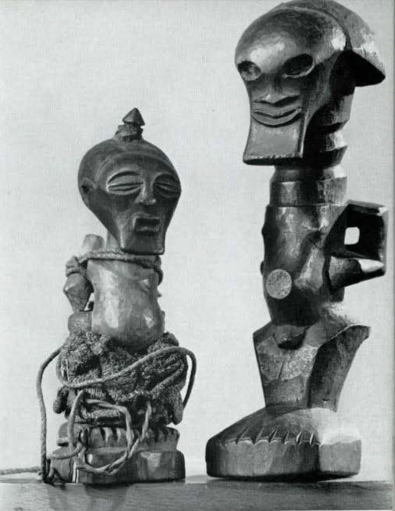 Two wooden figures, angular carving, one wrapped in rope.