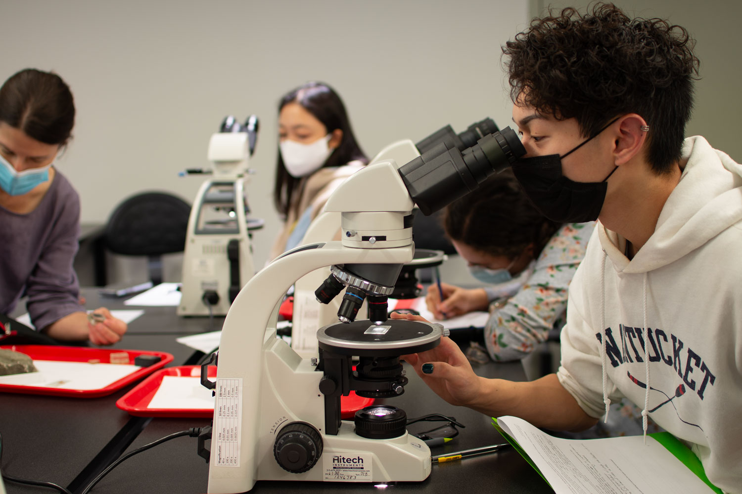 A student using a microscope in the lab.