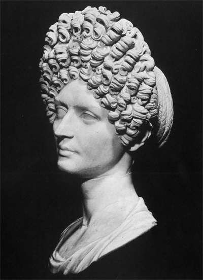 An outstanding example of a Roman portrait bust showing the flamboyant feminine hair style of the Flavian period, toward the end of the first century A.D. It possibly represents Julia, daughter of the emperor Titus