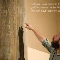 Nicholas Harris points to the graffitied column in the Penn Museum Egypt (Sphinx) Gallery.