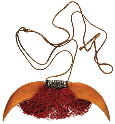 A necklace made of armadillo clawas and a fringe of red threads
