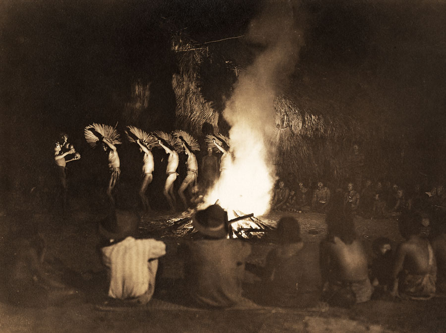 A bororo dance taking place in front of a fire while the expedition watches