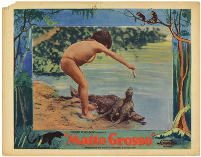 A colorful card that says Matto Grosso amd shows a child feeding otters