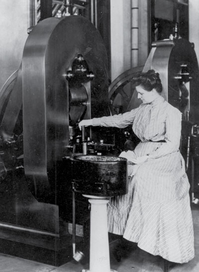 A woman working at a large machine