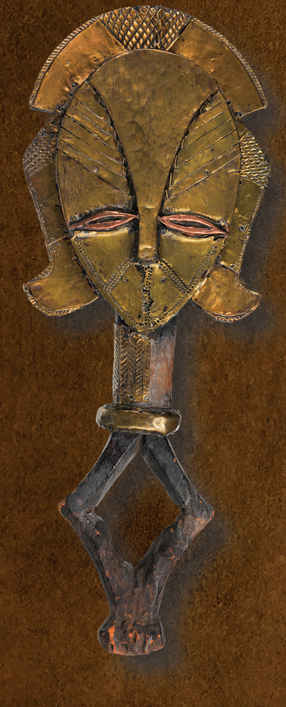Guardian figure in the shape of stylized face on a handle