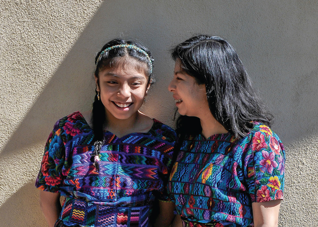 Two women wearing Maya cloth