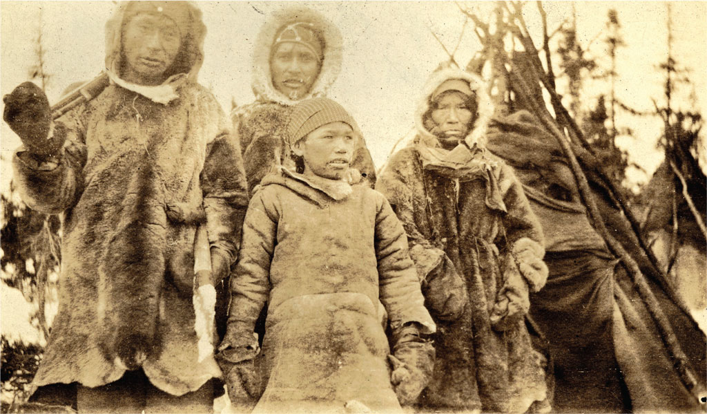 Group of Naskapi in thick fur coats.