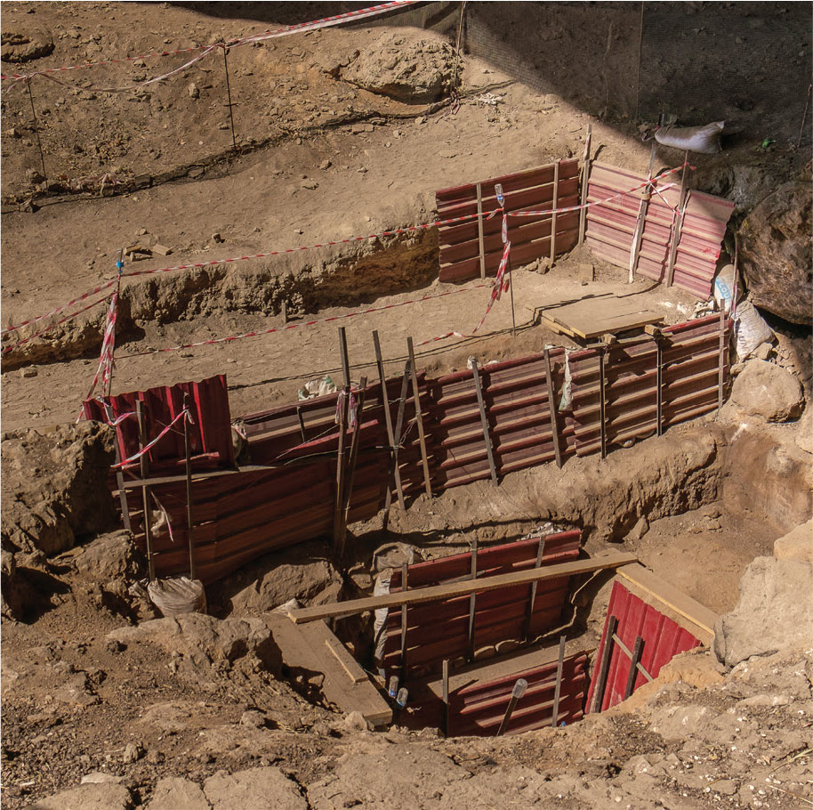 Stepped excavation terraces with wood fences in the Shanidar Cave.