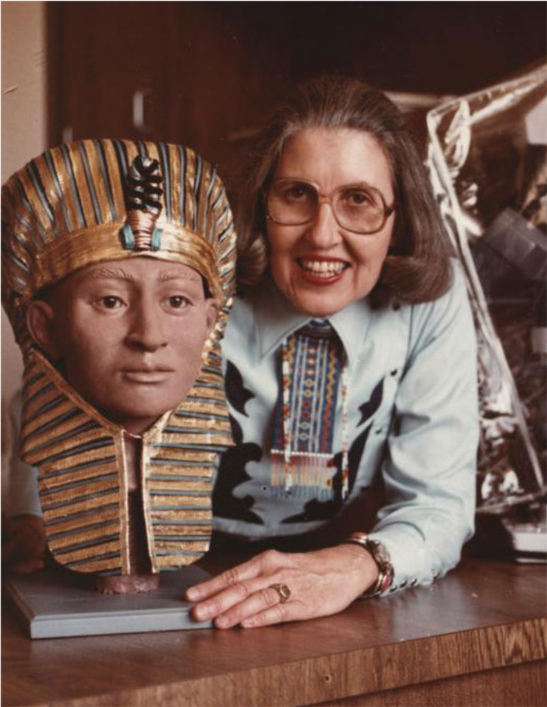 Betty with a reconstruction of King Tut's head wearing a headdress.