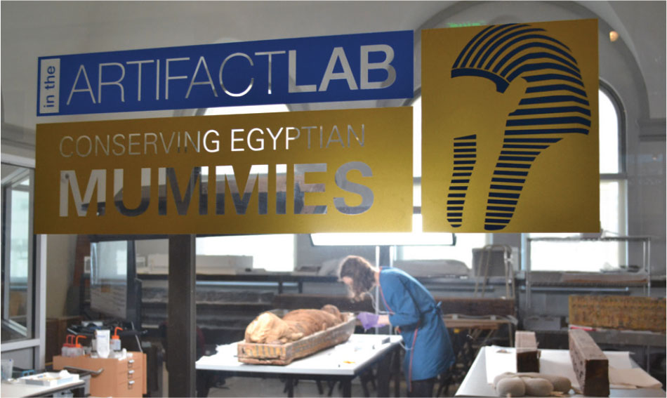 The Artifact Lab, a conservator working in the background.