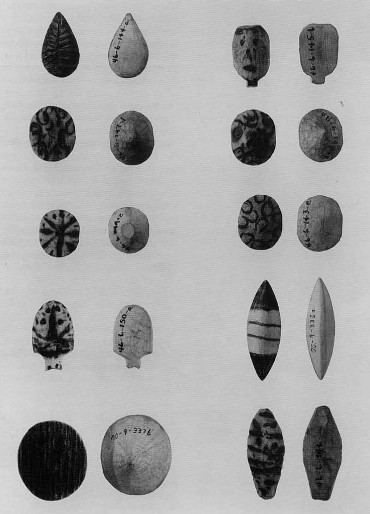 The obverse and reverse of ten different wooden dice in a variety of shapes and marking.