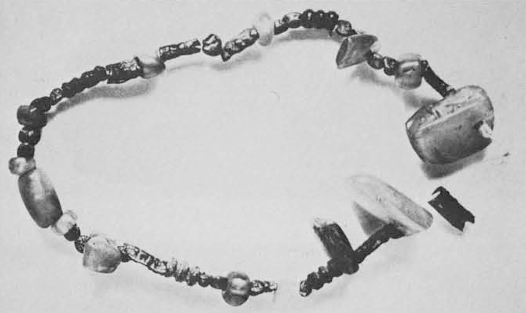 A beaded necklace, beads are in a variety of shapes and sizes.