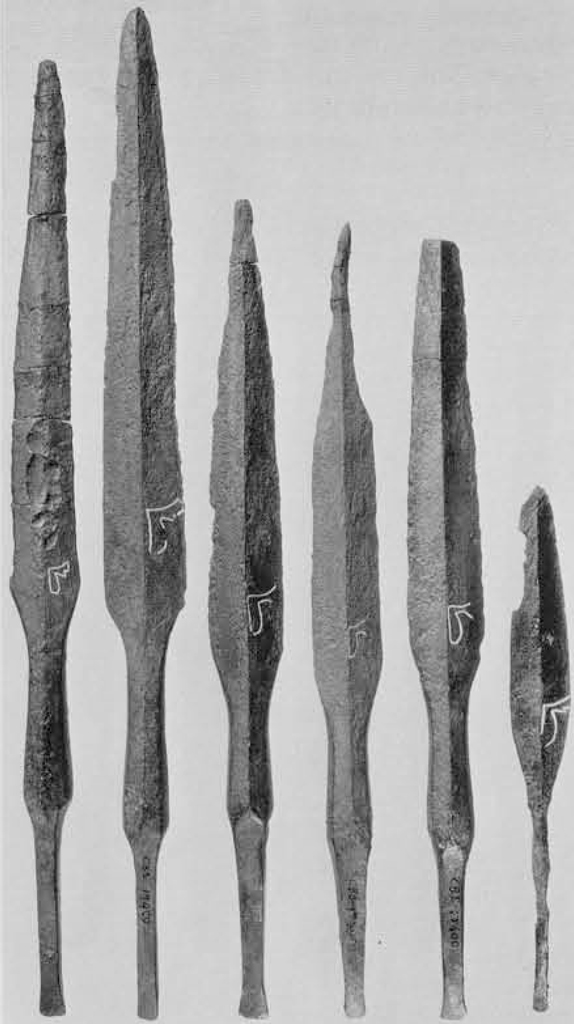Six spear heades, each with a bull's leg marking etched into the blade.