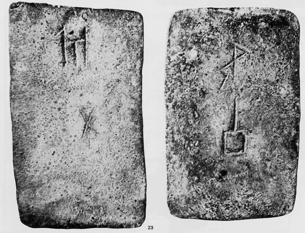 Rectangular ingot with two symbols engraved on it.