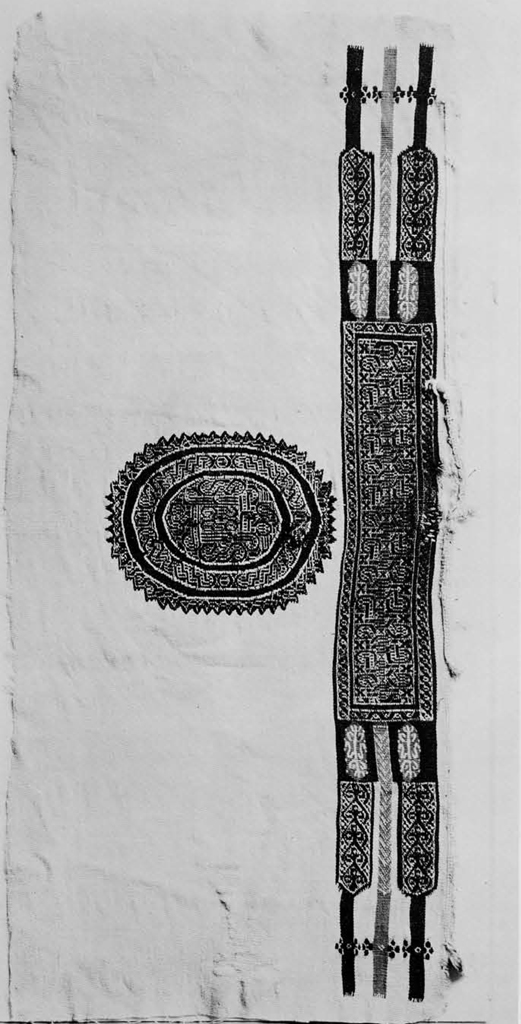 Textile fragment with a intricate medallion on the left of an intricate band of pattern.