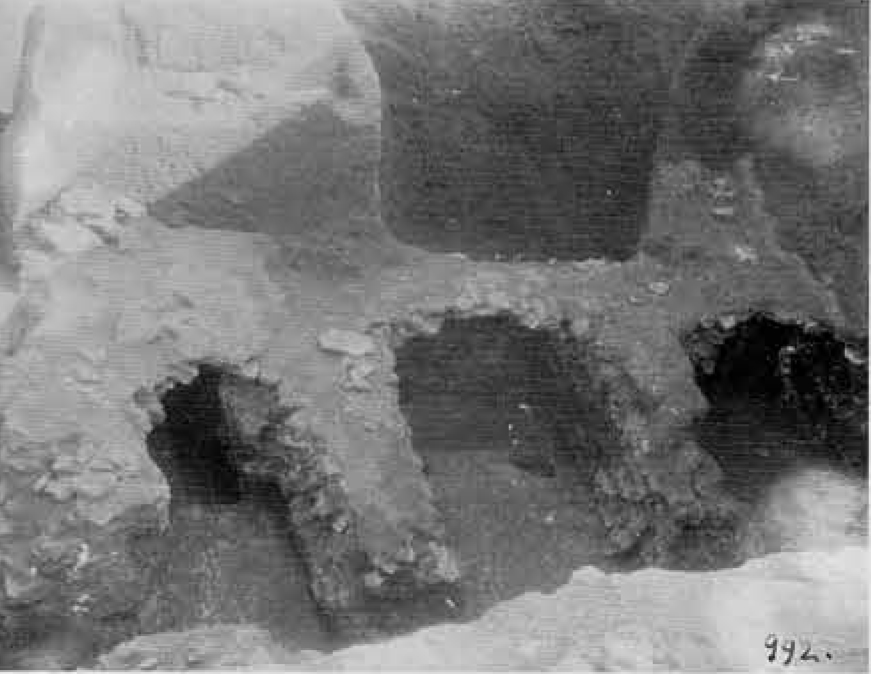 Three tomb entrances that have been dug out.