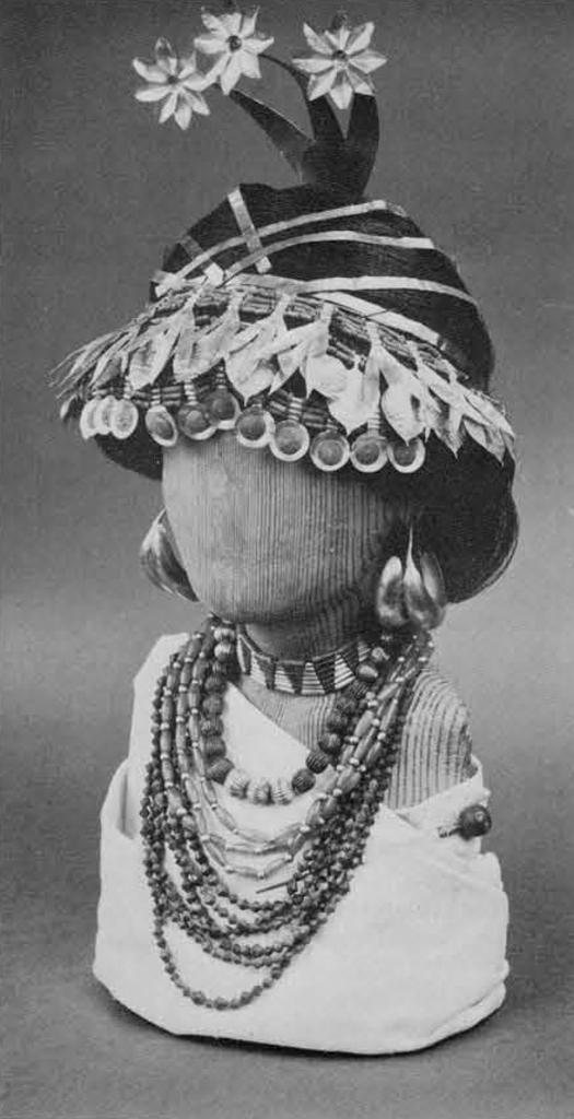 A wood bust wearing necklaces, earings, and hairpieces from the Great Death Pit.