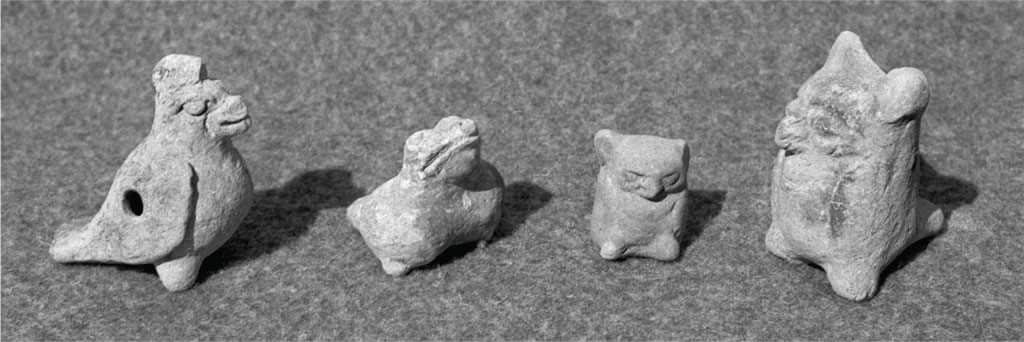 Four ceramic whistles in various animal shapes.