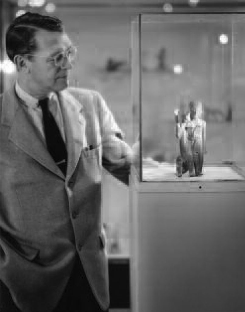 Froelich Rainey examines artifacts from Waldemar Julsrud’s collection on display at the Museum.