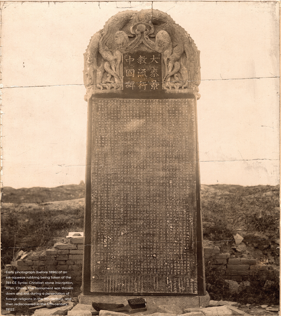 Photograph of a monument covered in writing.